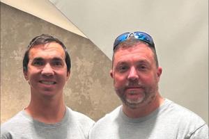 Matthew Bohl (left) and Ron Bohl stand with their "Living Proof" and "Giving Proof" tee shirts following a paired donor kidney transplant.